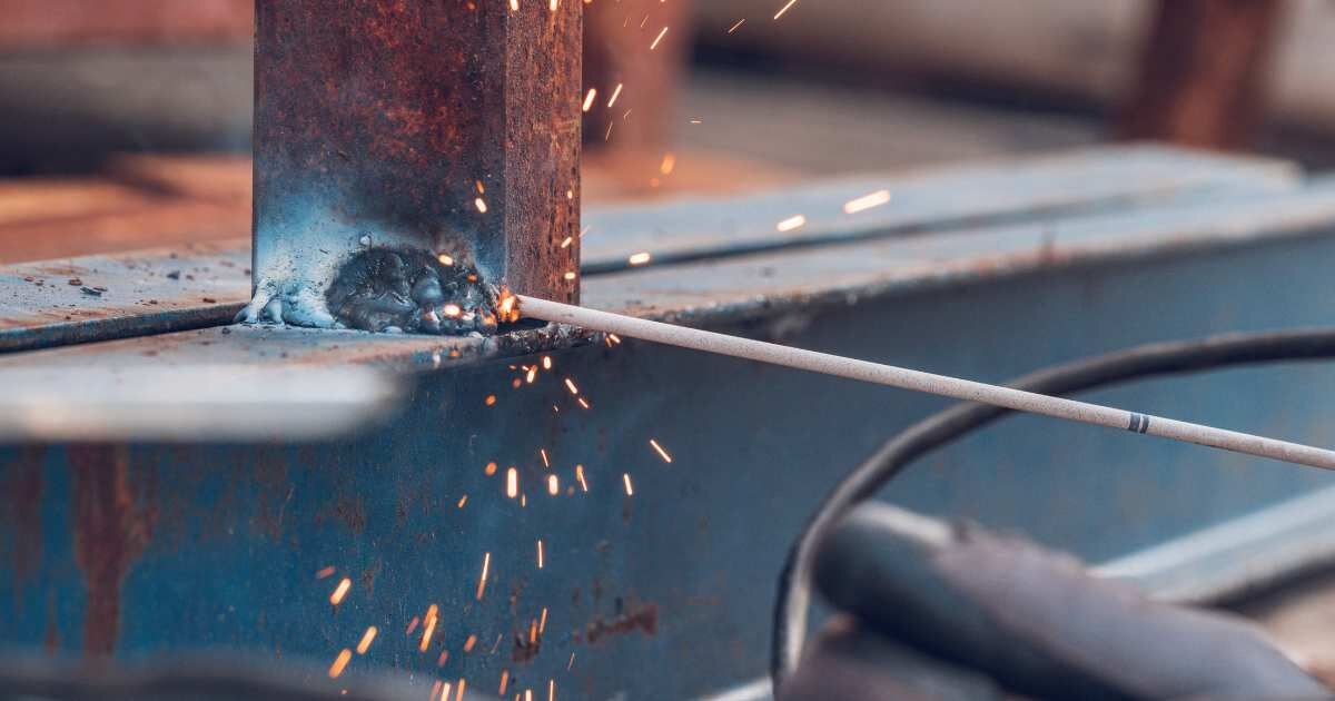 Close-up of welding sparks as a worker welds metal